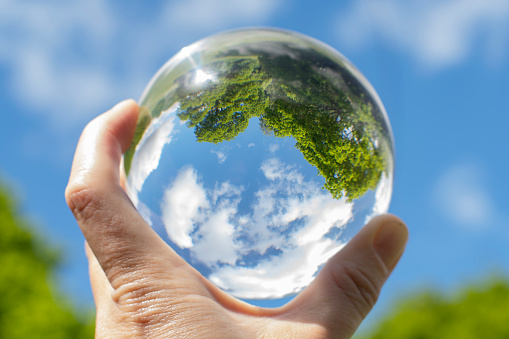 Nature outside and inside. Focus  taking care of nature and the climate shown with nature encased in a luminous crystal ball.
