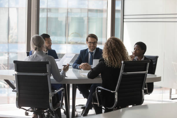 istock Diverse millennial business group brainstorming, at conference table 1398758186