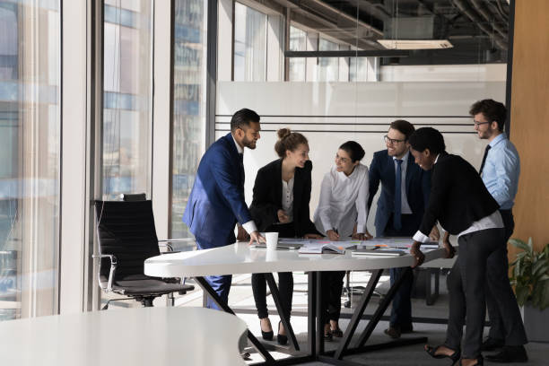 Diverse group of happy employees analyzing reports together