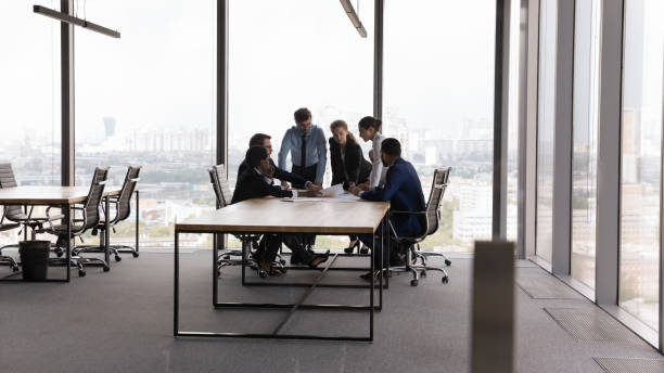 istock Diverse millennial business team meeting at modern office conference table 1398758228