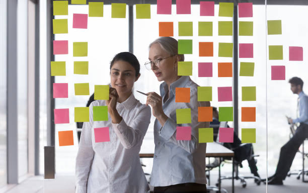 istock Mature mentor teaching Intern to work with Kanban board 1398758244
