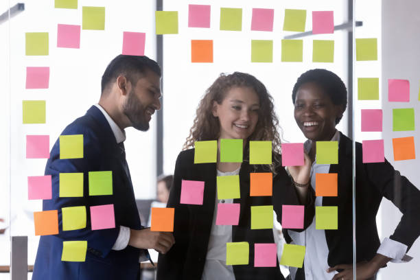 istock Happy multiethnic business team writing tasks on colorful notes 1398758265
