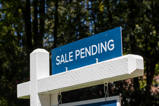 Sale Pending Closeup of a "Sale Pending" real estate sign outside a residential single-family house on the market. Pandemic housing market frenzy concept. pacific northwest photos stock pictures, royalty-free photos & images