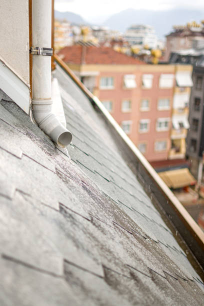 istock Rain storm water draining into roof edge gutter 1398762818