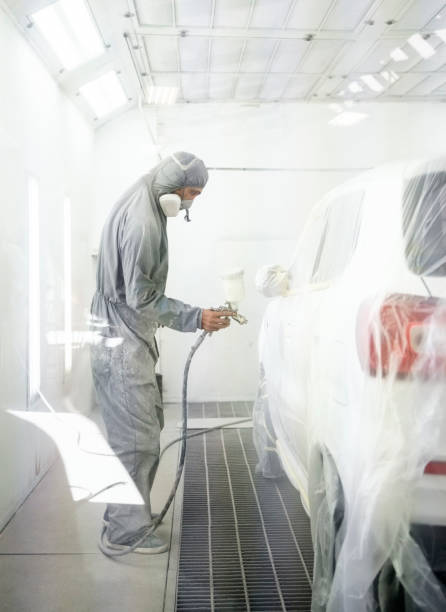 istock Professional painter painting a car in dust free room 1398762980