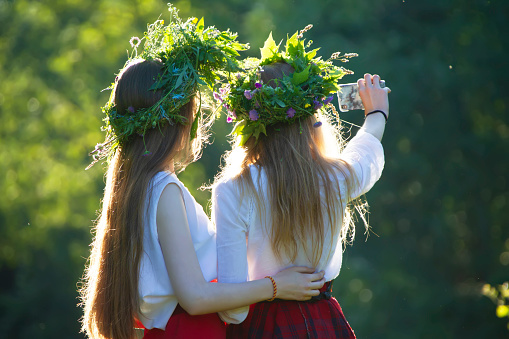 Two girls on Ivan Kupala in embroidered shirts and wreaths.