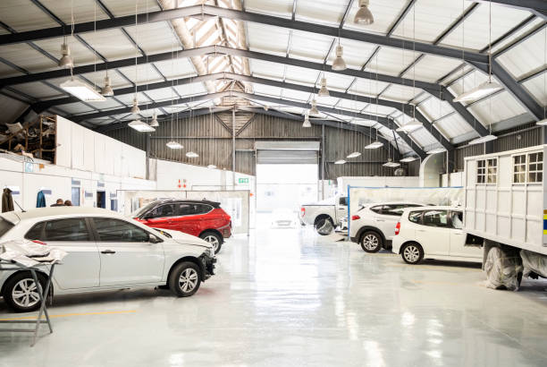 Interior of automotive service center Interior of automotive service center for car maintenance with many vehicles repair garage stock pictures, royalty-free photos & images