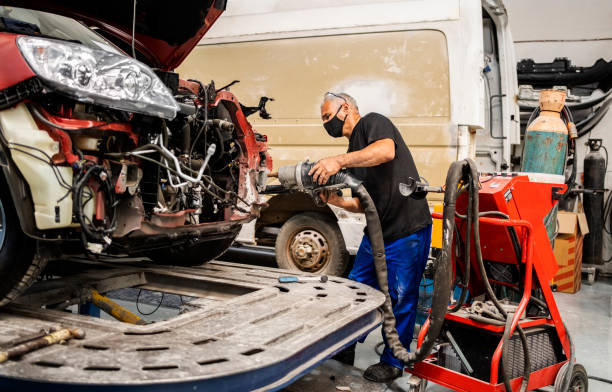 soldadura por puntos mecánicos de una pieza de automóvil en el garaje de automóviles - car auto repair shop repairing accident fotografías e imágenes de stock