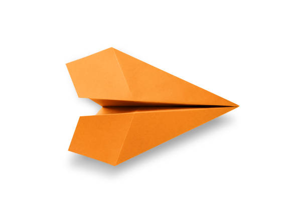 Orange paper plane origami isolated on a blank white background