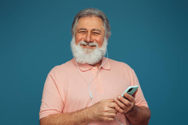 istock Portrait of emotional old man using smart phone 1398764254