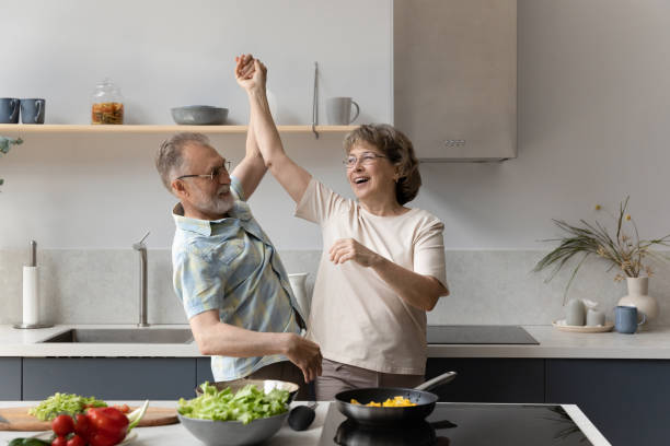 istock Happy middle aged man dancing with laughing elderly senior wife. 1398764389