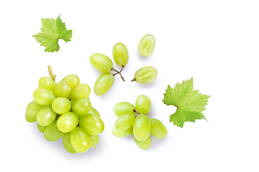 Green muscat grapes and half sliced isolated on white background. Top view. Flat lay. Grape pattern texture background.