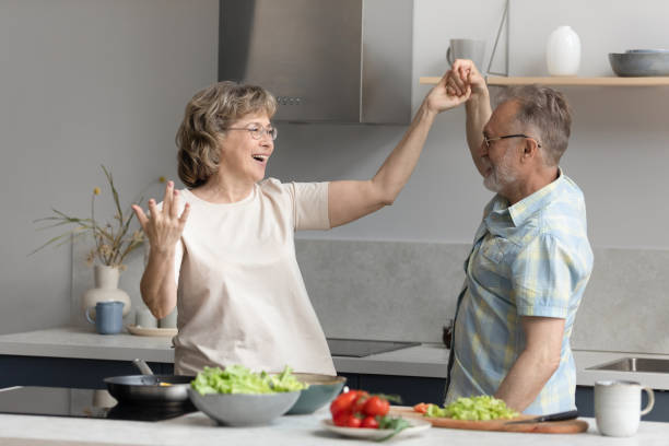 istock Happy middle aged couple dancing in kitchen. 1398765280