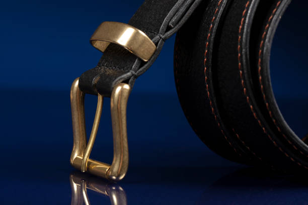istock Black leather belt on a dark blue background. 1398765299