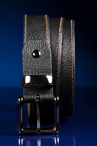 istock Black leather belt on a dark blue background. 1398765332