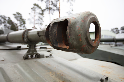 The muzzle of a modern battle tank. Military vehicle.