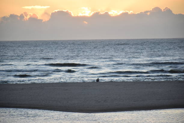 istock A FISHERMAN (ANGLER) ON SEASHORE - A SUNSET VIEW 1398765470