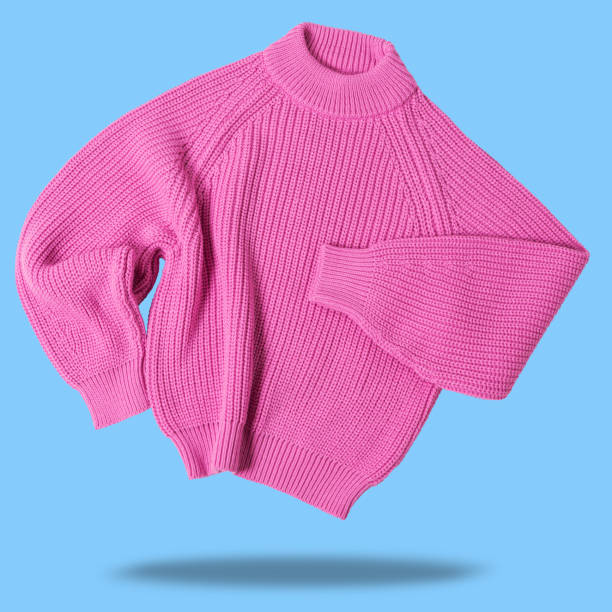 istock pink wool sweater, levitates as if dancing, casts a shadow, on a blue background 1398765510