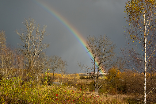 Blue sky with clouds and a rainbow