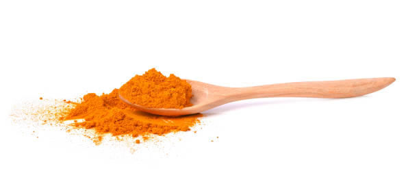 istock Turmeric (Curcuma) powder in wooden spoon on white background 1398769702