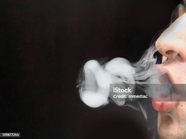 Smoking And Blowing Os With The Smoke 1 Stock Photo - Download Image Now - Accidents and Disasters, Addiction, Adult