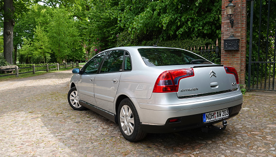 Lage, Germany - May 14 2022 - Silver Citroen C5 from 2007 on cobblestones in a rural environment. It's the first generation model of this car, which was produced between 2001 and 2007.