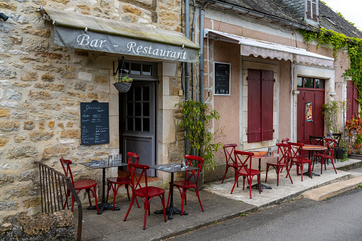 Carennac, France - 13 May, 2022: idyllic street café and restaurant in the historic village of Carennac in the Dordogne Valley