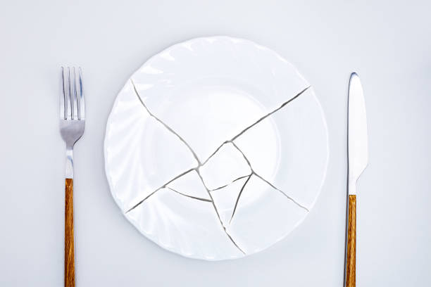 istock Top view of broken plate on kitchen table. Concept food crisis. 1398775116