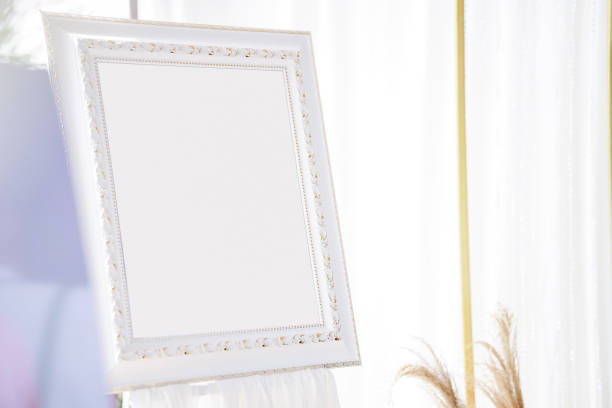 istock A picture frame or signboard with a blank white space is set up for wedding decorations. Clipping path. 1398775127