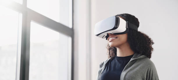 Young woman experiencing virtual reality eyeglasses headset stock photo