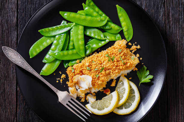 istock Baked Haddock with Crackers toppings and snow peas 1398776815