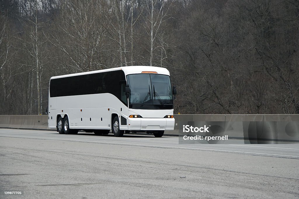 White Bus White Tour or Charter Bus on Highway.  Could Also Be Expensice Luxury RV Coach Bus Stock Photo