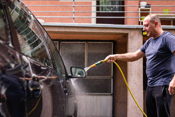 istock Mid adult man washing car 1398778087