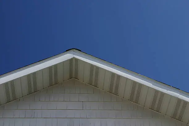 White roof line with deep blue summer sky