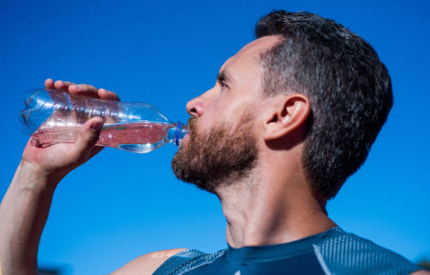 istock bearded man drinking water because of thirst after training, sport and hydration 1398780022