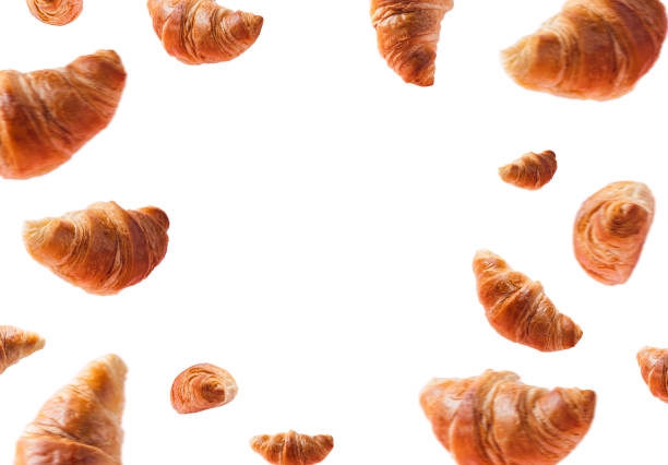 istock Fresh croissants levitating or flying on white isolated background, copy space 1398784012