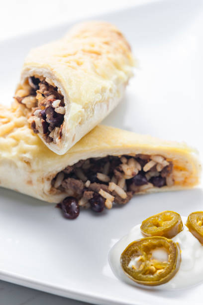 istock beef burrito with rice and beans served with whipped cream and jalapenos 1398784281
