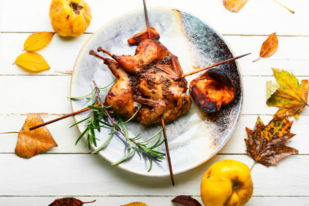 Shish kebab of quail and autumn quince on wooden skewers