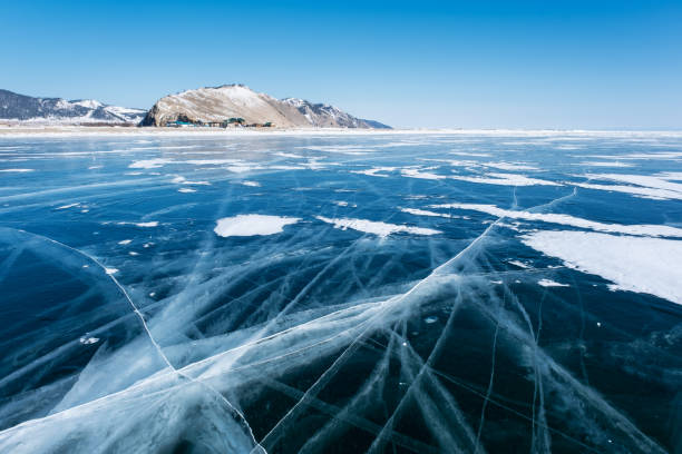 istock Clear ice on Baikal lake and village 1398785208