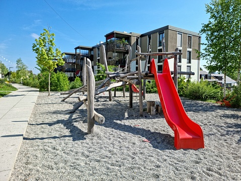 Colourful preschool playground with playground equipment and sunshade full frame horizontal composition