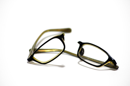 Trendy broken eyeglasses on white background