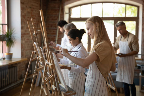 istock Multiethnic group of art school students drawing in paints 1398786612