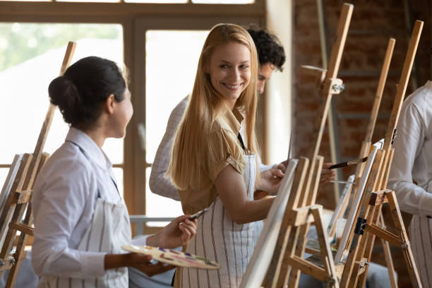 istock Happy hobby friends talking on art school class 1398786615