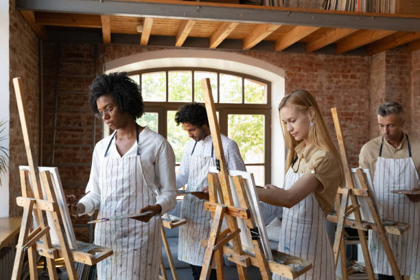 istock Multiethnic group of artist students drawing at easels 1398786616