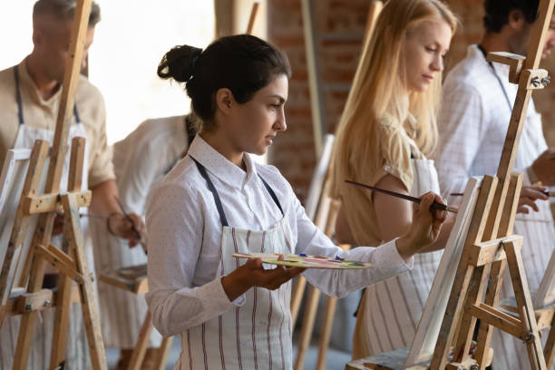 istock Focused inspired Indian artistic class student girl drawing in paints 1398786629