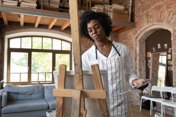 istock Relaxed Afro American professional artist working in home craft studio 1398786637