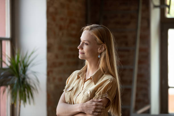 istock Peaceful thoughtful long haired young woman looking at window 1398786679