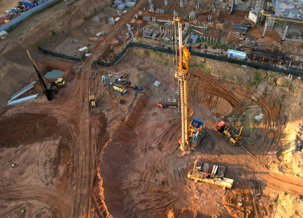 istock Deep foundation machine. Drilling rig and Pile driver at construction site. Pile driven into ground by vibrating hydraulic hammer. 1398787253