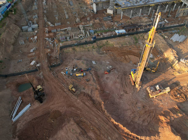 istock Deep foundation machine. Drilling rig and Pile driver at construction site. Pile driven into ground by vibrating hydraulic hammer. 1398787275