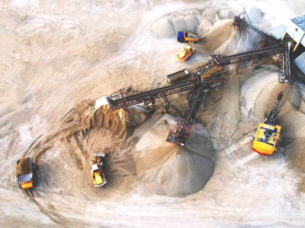 istock Sand Making Plant and Belt conveyor in mining quarry. Mining excavator loading sand in haul truck in opencast. 1398787418